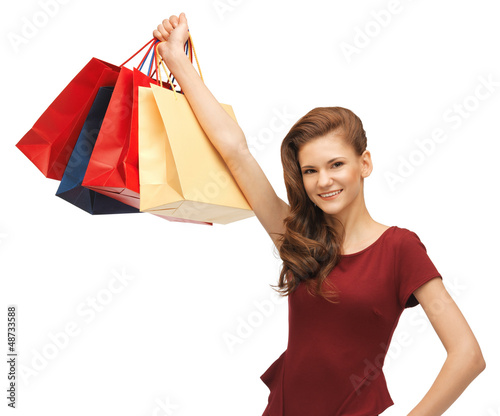 Photo: teenage girl in red dress with shopping bags teenage girl in red dress with shopping bags