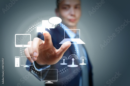 Photo: hand pushing on a touch screen hand pushing on a touch screen