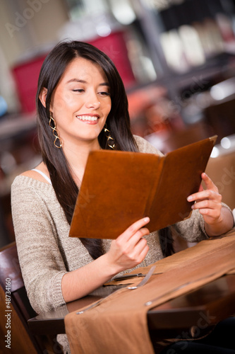 Photo: Woman looking at the menu Woman looking at the menu