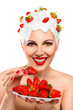 Young woman eating red ripe strawberry