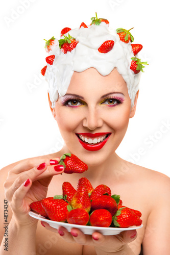 Photo: Young woman eating red ripe strawberry Young woman eating red ripe strawberry