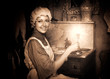 woman in old cap with candlestick