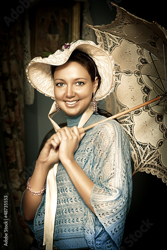 Photo: woman in old hat with a lace umbrella woman in old hat with a lace umbrella