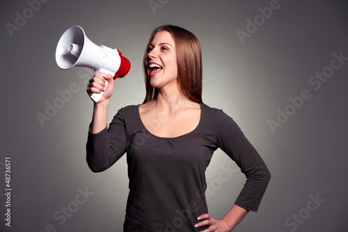 Photo: happy woman with loudspeaker happy woman with loudspeaker