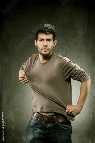 Photo: Pulling his tshirt for creating copy space Pulling his tshirt for creating copy space