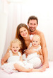 Photo: Happy young family. Indoors. Happy young family. Indoors.