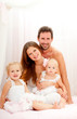 Happy young family. Indoors.