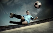 football player on soccer field of stadium with drammatic sky