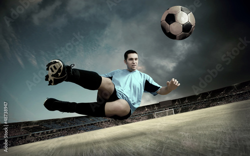 Photo: football player on soccer field of stadium with drammatic sky football player on soccer field of stadium with drammatic sky