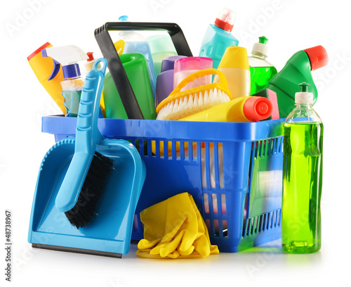 Photo: Shopping basket with detergent bottles isolated on white Shopping basket with detergent bottles isolated on white