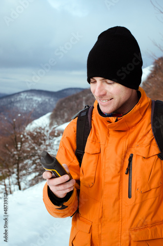 Photo: Backpacker looking at GPS Backpacker looking at GPS