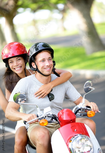Photo: Free young couple on scooter on summer vacation Free young couple on scooter on summer vacation
