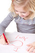 little girl writting I love you