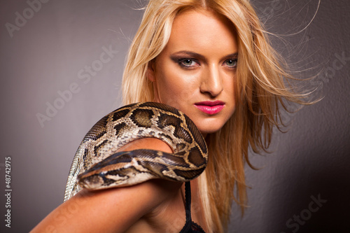 Photo: attractive young woman with python on her shoulder attractive young woman with python on her shoulder