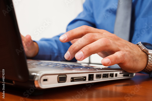Photo: Man working on his laptop Man working on his laptop