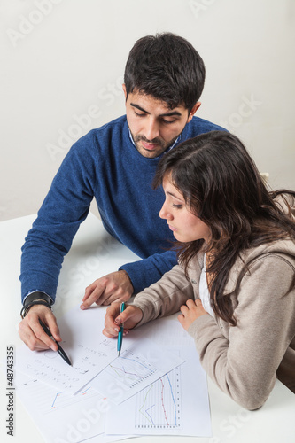 Photo: Young Woman Studying with Her Tutor Young Woman Studying with Her Tutor
