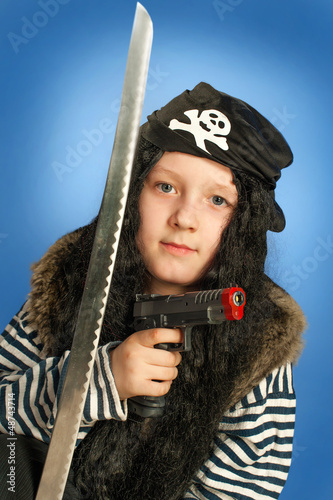 Photo: Pirate boy with gun and sword. Halloween finery. Pirate boy with gun and sword. Halloween finery.