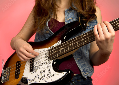 Photo: Young woman punk woman playing bass guitar Young woman punk woman playing bass guitar