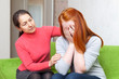 Mature mother comforts crying daughter