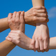 Couple hands connecting to a chain with sky