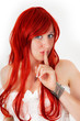 Woman with red hair keeps fingers to his mouth