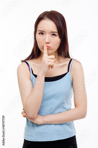 Photo: Young Asian woman gesture dont' make sound. Young Asian woman gesture dont' make sound.