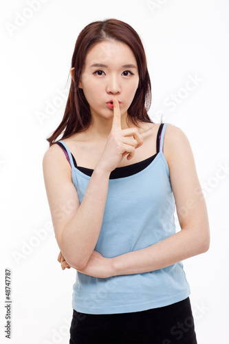 Photo: Young Asian woman gesture dont' make sound. Young Asian woman gesture dont' make sound.
