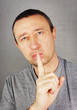 Man makes a gesture Keep quiet!