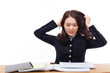 Photo: Young Asian student having trouble on desk. Young Asian student having trouble on desk.
