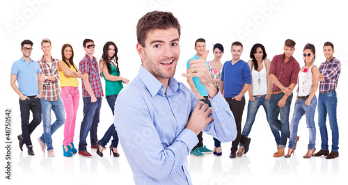 Photo: man making the call me hand gesture in front of team man making the call me hand gesture in front of team