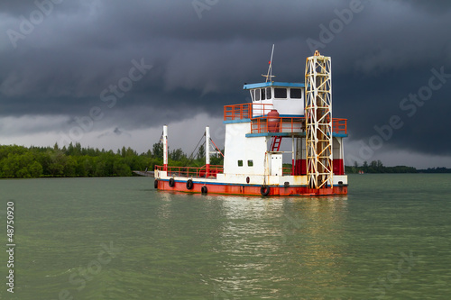 Photo: Ferry on the river before storm in Koh Kho Khao, Thailand Ferry on the river before storm in Koh Kho Khao, Thailand