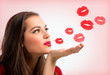 Portrait of a beautiful woman blowing  red kisses