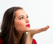 Portrait of a beautiful woman blowing  a kiss