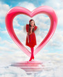 Beautiful angel woman sending love from the heart shaped gate