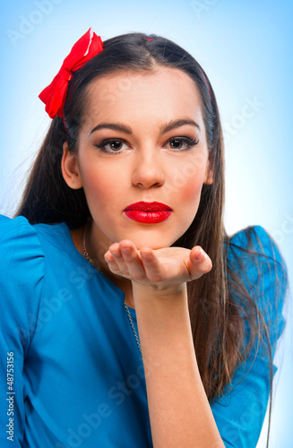 Photo: Portrait of a beautiful woman in blue sending kisses Portrait of a beautiful woman in blue sending kisses