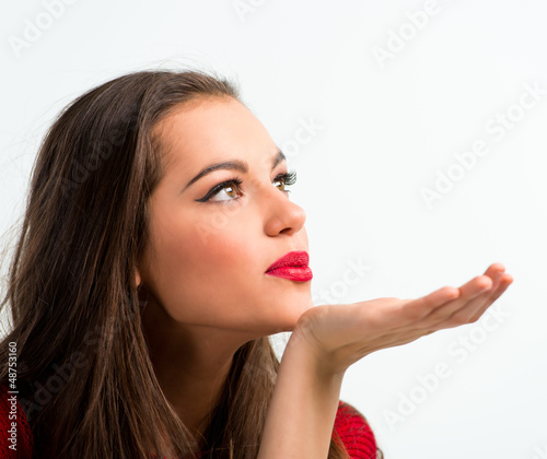 Photo: Portrait of a beautiful woman blowing a kiss Portrait of a beautiful woman blowing a kiss