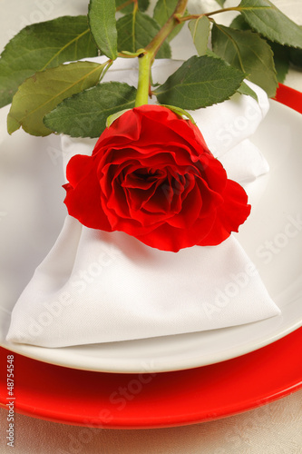 Photo: Romantic dinner setting with a rose Romantic dinner setting with a rose