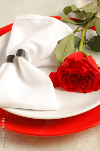 Photo: Romantic dinner setting with a rose Romantic dinner setting with a rose