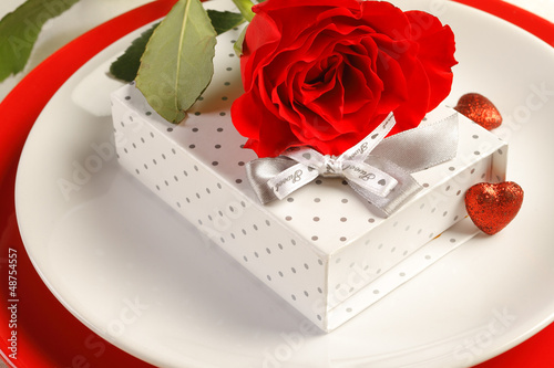 Photo: Romantic dinner setting with a rose and gift box Romantic dinner setting with a rose and gift box