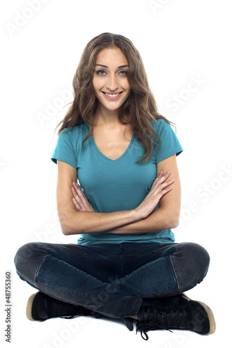 Photo: Pretty woman seated on the floor with hands crossed Pretty woman seated on the floor with hands crossed