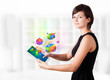 Young woman looking at modern tablet with pie charts