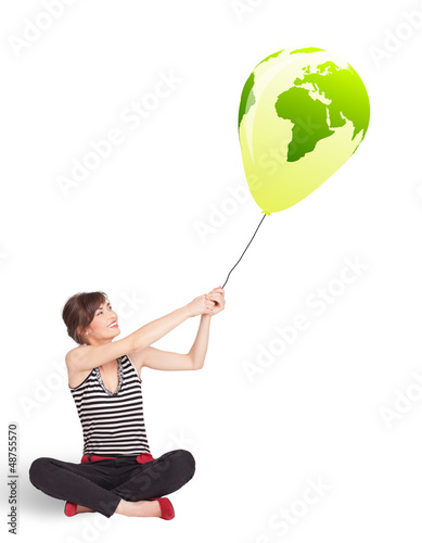 Photo: Happy lady holding a green globe balloon Happy lady holding a green globe balloon