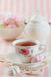 Black tea in elegant cup with  meringue cookies
