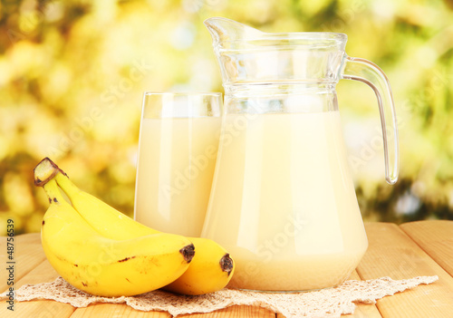 Photo: Full glass and jug of banana juice and bananas Full glass and jug of banana juice and bananas
