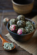 Green tea balls and lemon grass in a ceramic dish