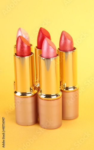 Photo: Lipsticks on yellow background Lipsticks on yellow background