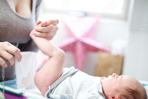 Photo: Mother changing a baby's nappy Mother changing a baby's nappy