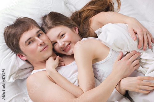 Photo: Young man and woman in a bed Young man and woman in a bed