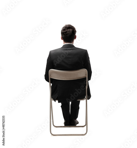 Photo: businessman sitting back businessman sitting back