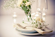 table setting with roses in bright colors and vintage crockery